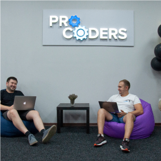 Two developers sitting in chairs and laughing