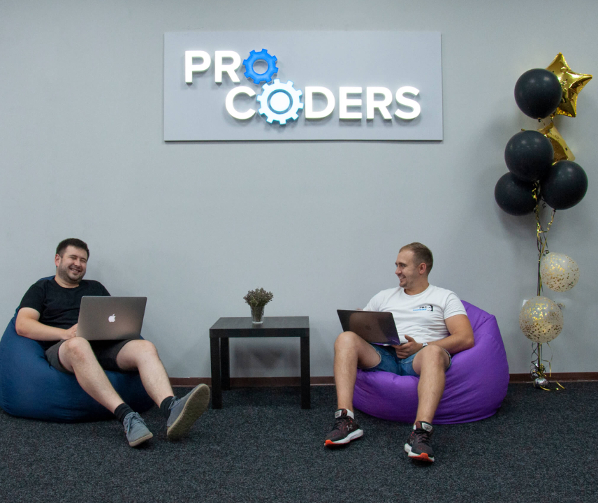 Software Developers sitting on bag chairs and laughing